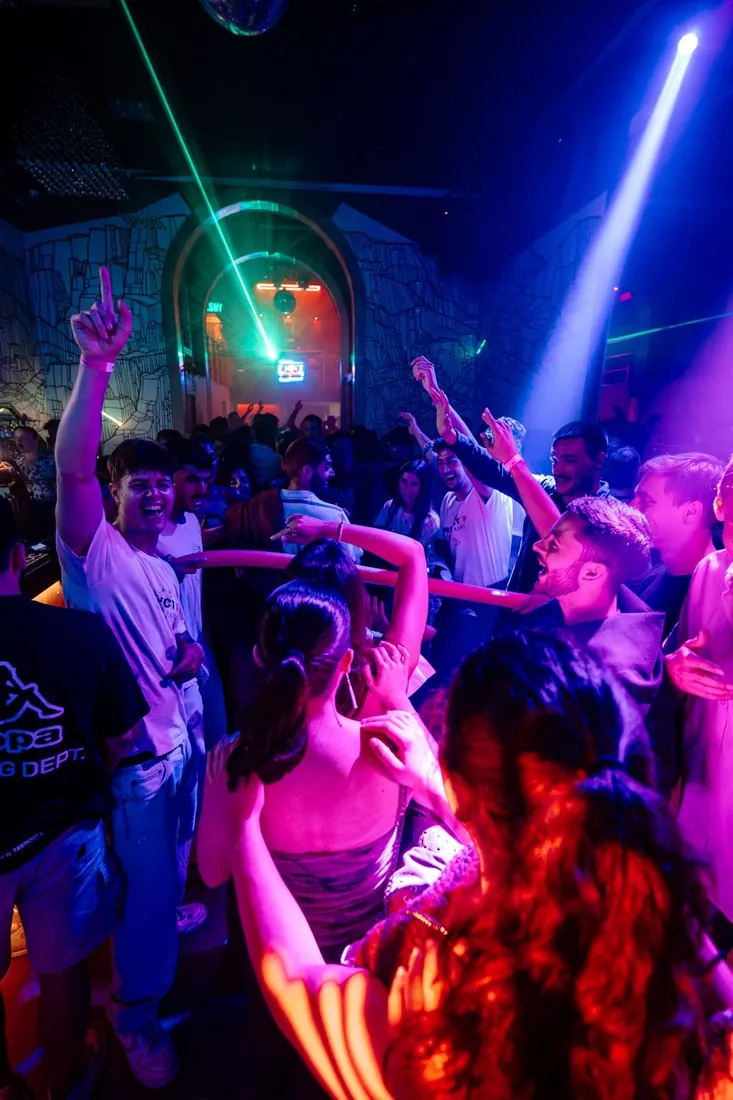 Crowd dancing under lasers at the VIP club